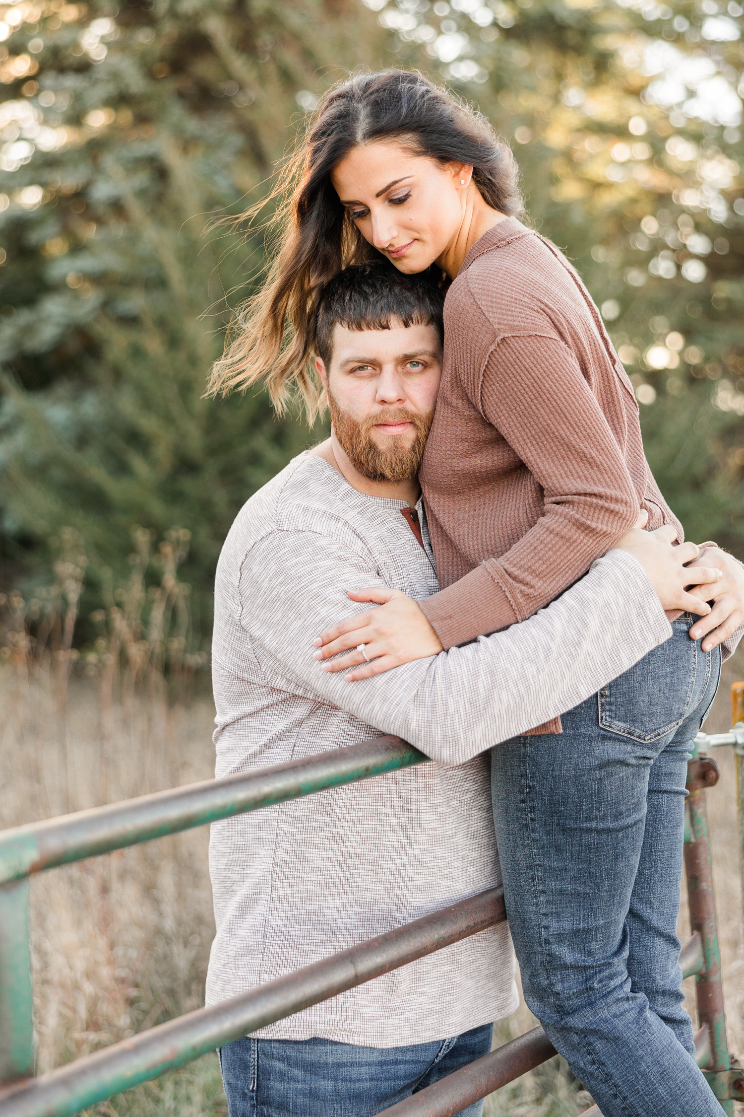 Kylie climbs a livestock gate while Drake embraces her from the other side of the gate | CB Studio