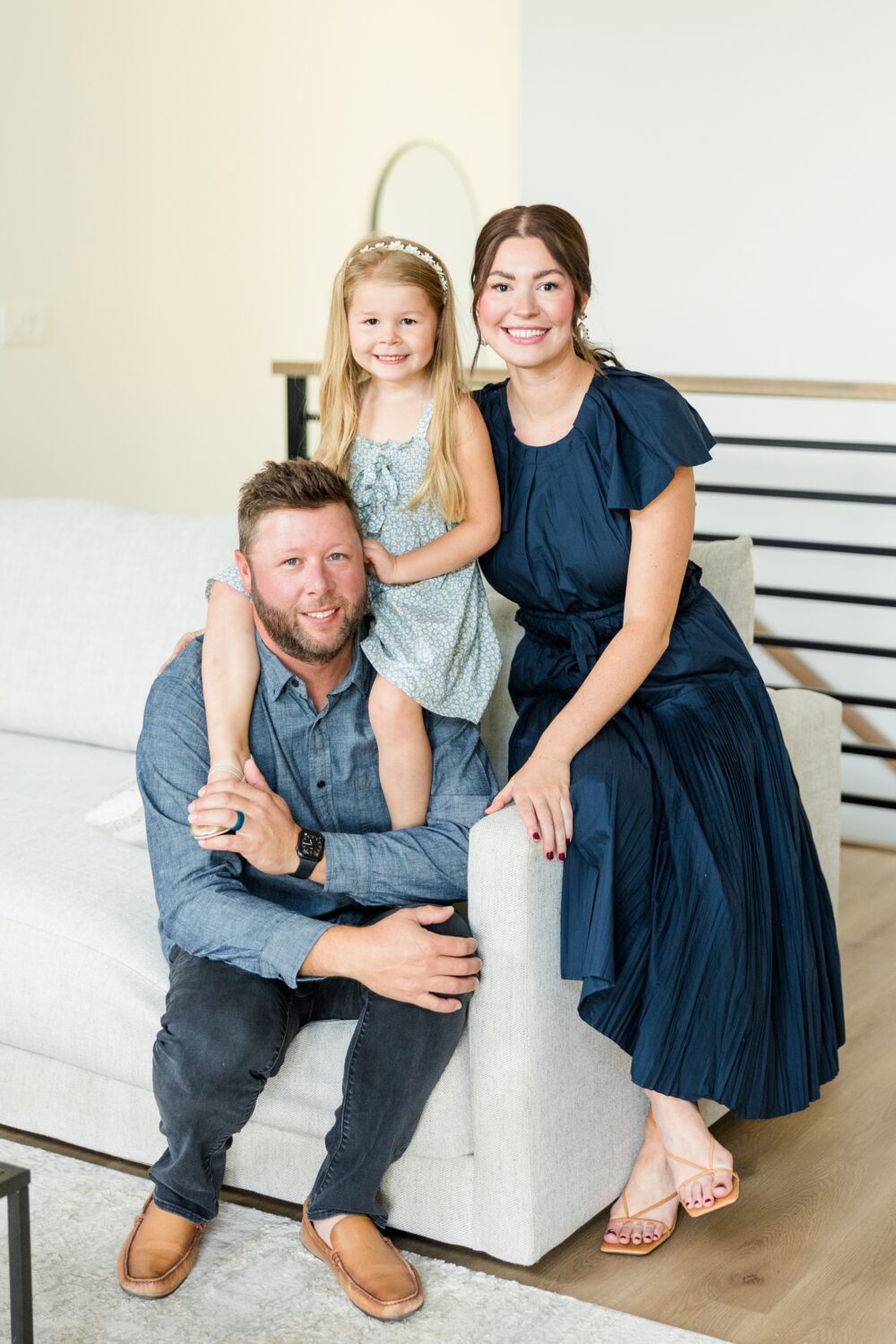 Best of 2024 Families | The Arndorfer family sit on their couch in their neutral, simple, modern home | CB Studio