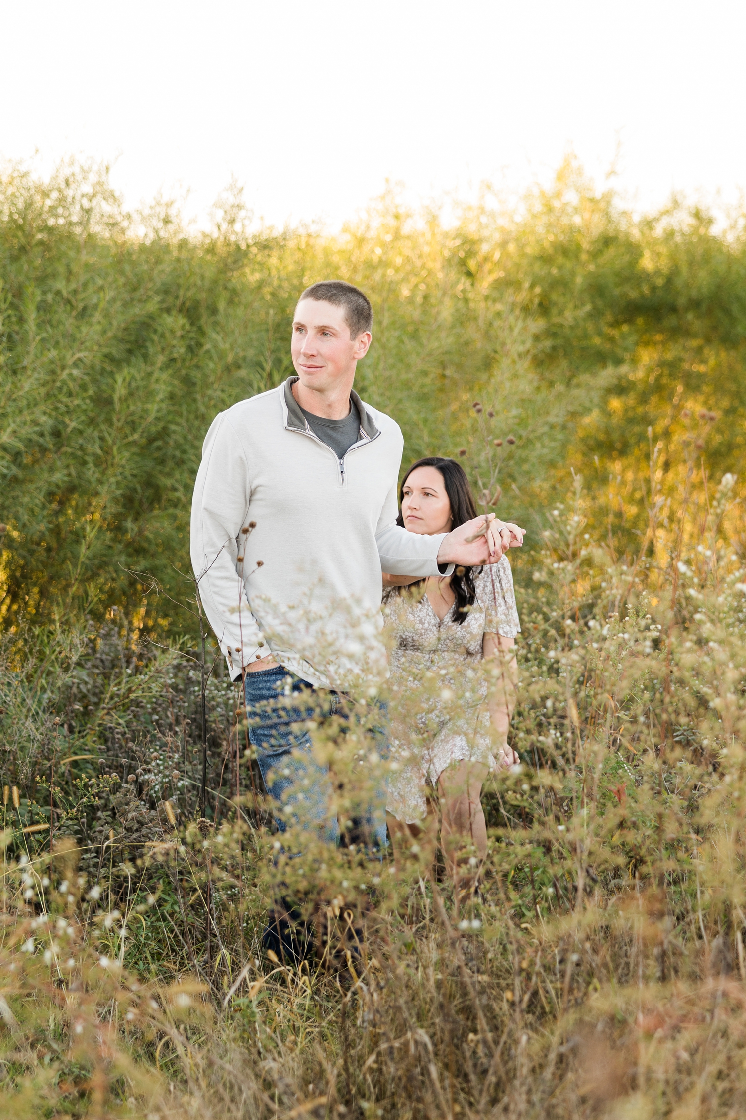 Best of 2024 Engagements | Brandon leads Haley across a grass field while holding her hand | CB Studio