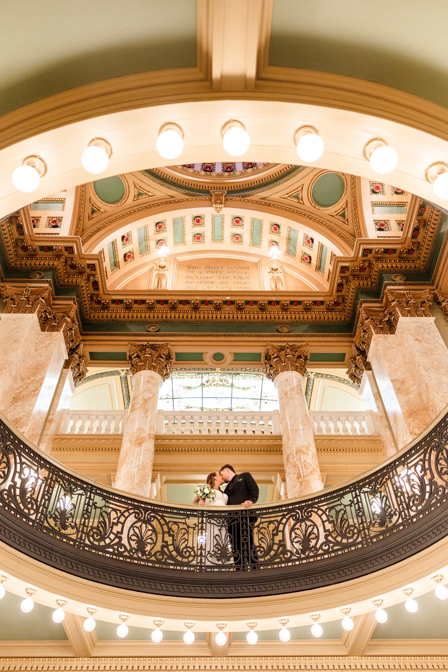 Newly married, Lisa and Chris share a kiss surrounded by beautiful and iconic architecture inside the Polk County Courthouse in Des Moines, Iowa | CB Studio