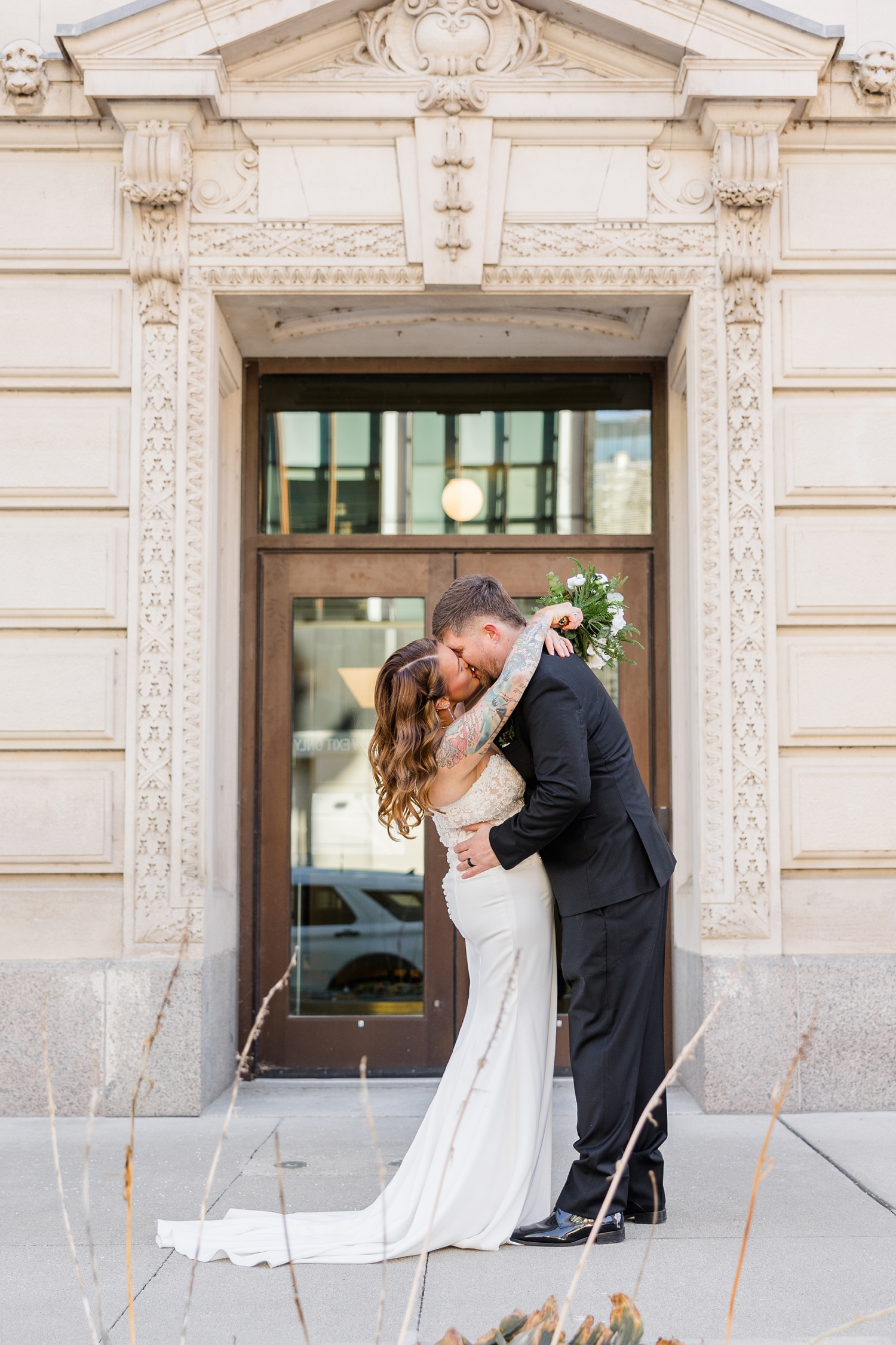 Chris leans his bride back for a kiss in front of the Polk County Courthouse | CB Studio