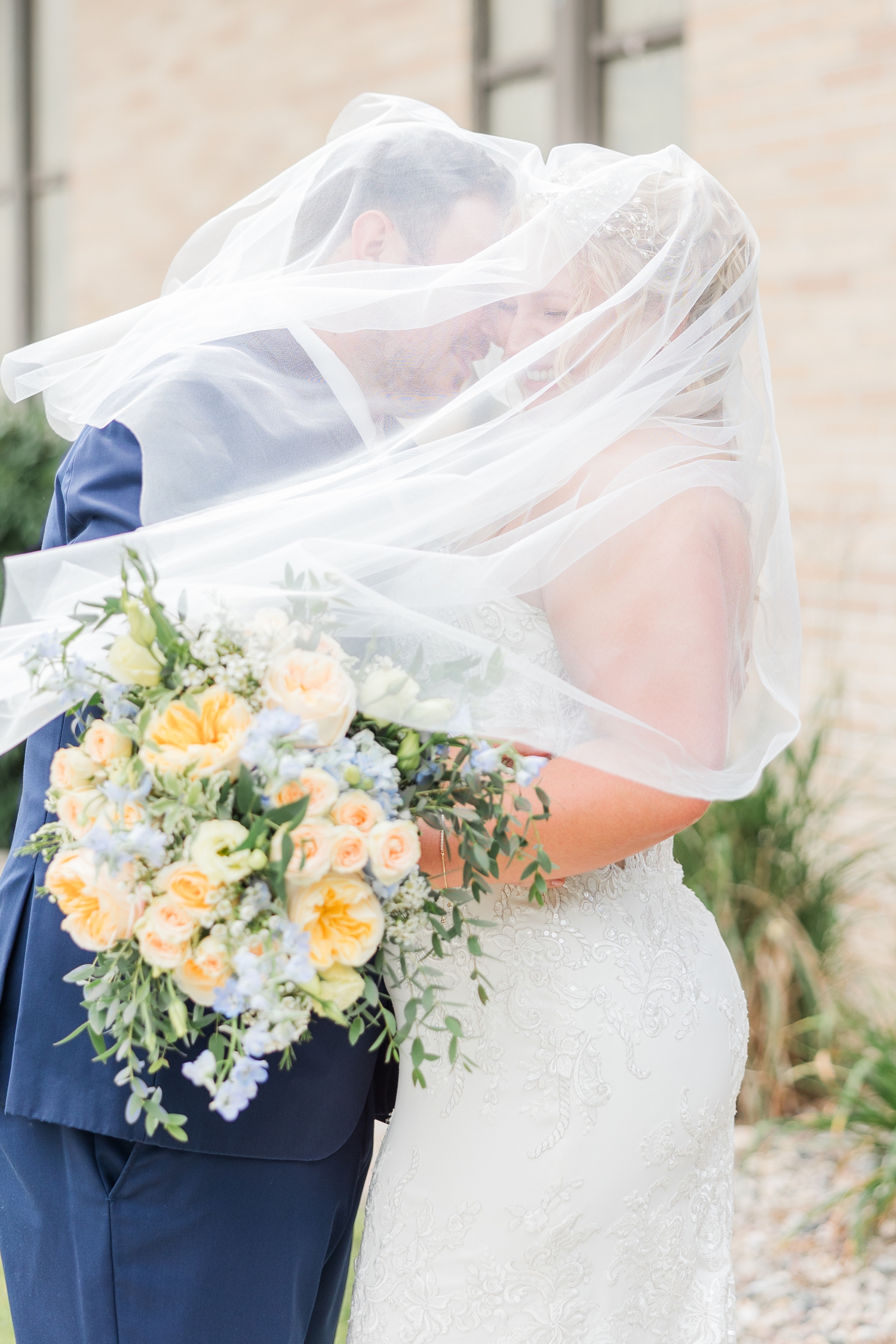 Connor nuzzles Natalie's temple as they are engulf under Natalie's blusher veil and the wind gentle blows through | CB Studio