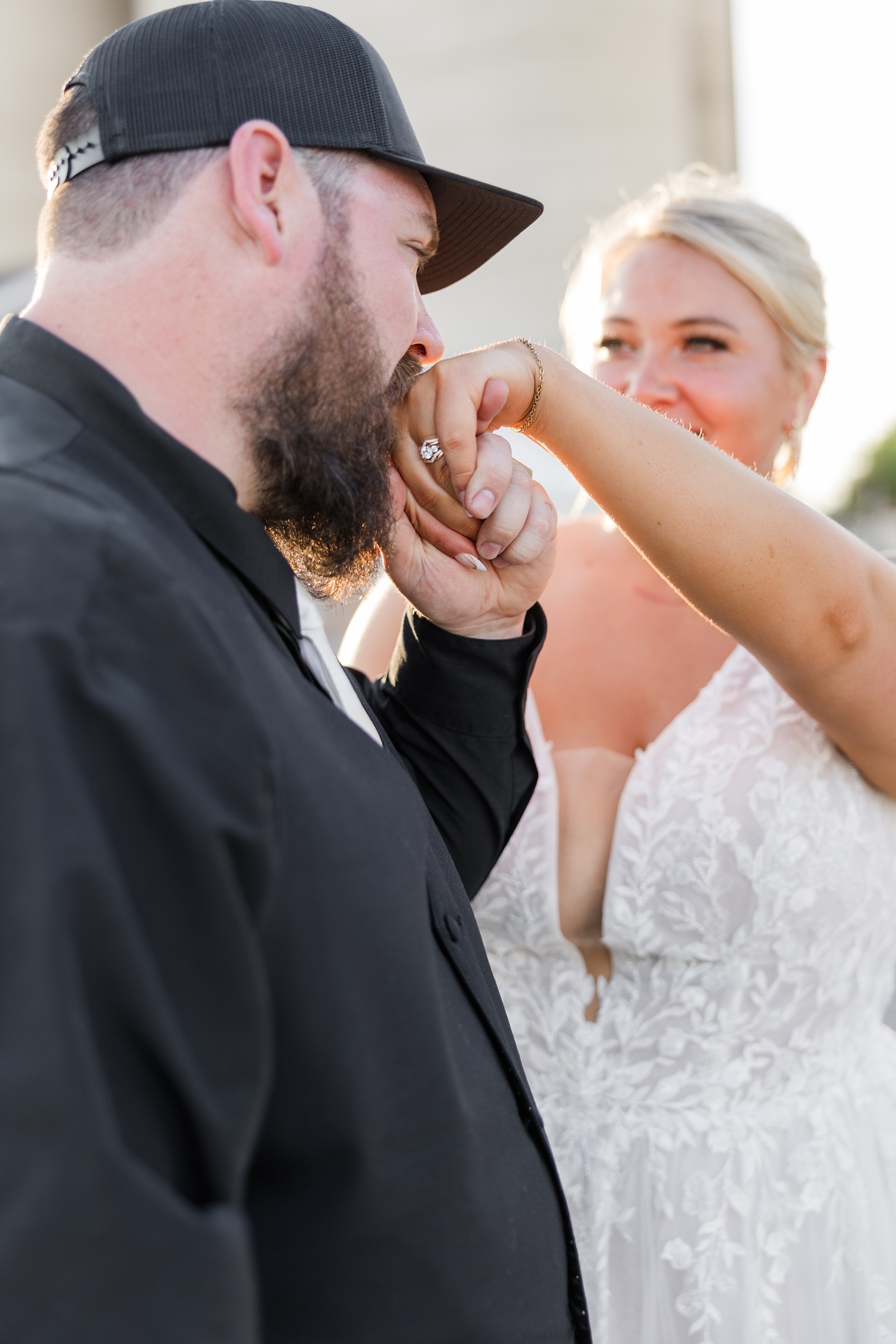 Dalton kisses Teri's hand prince charming style on Main St. in Wesley, IA during golden hour | CB Studio