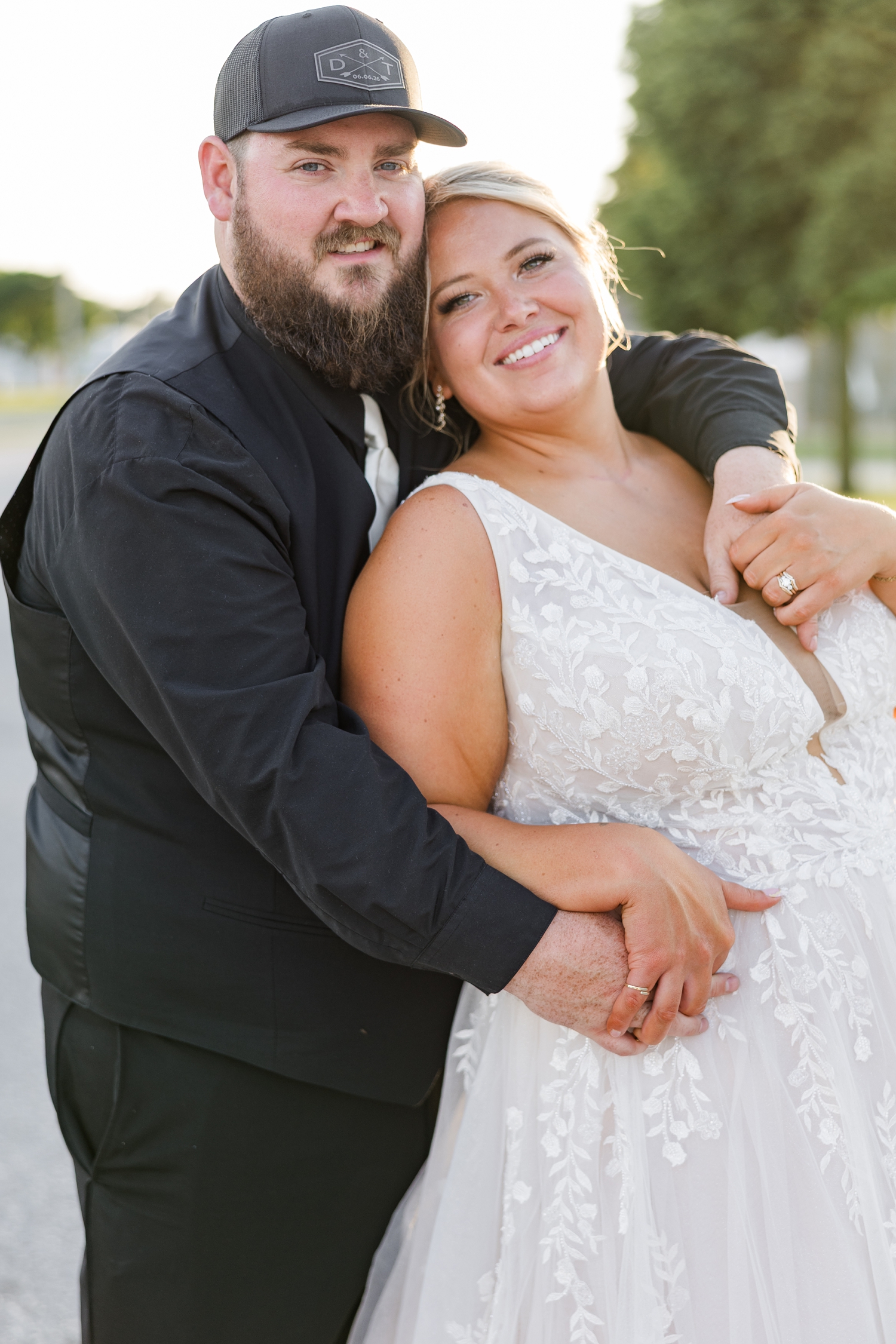 Dalton stands behind Teri as he embraces her on Main St. in Wesley, IA during golden hour | CB Studio