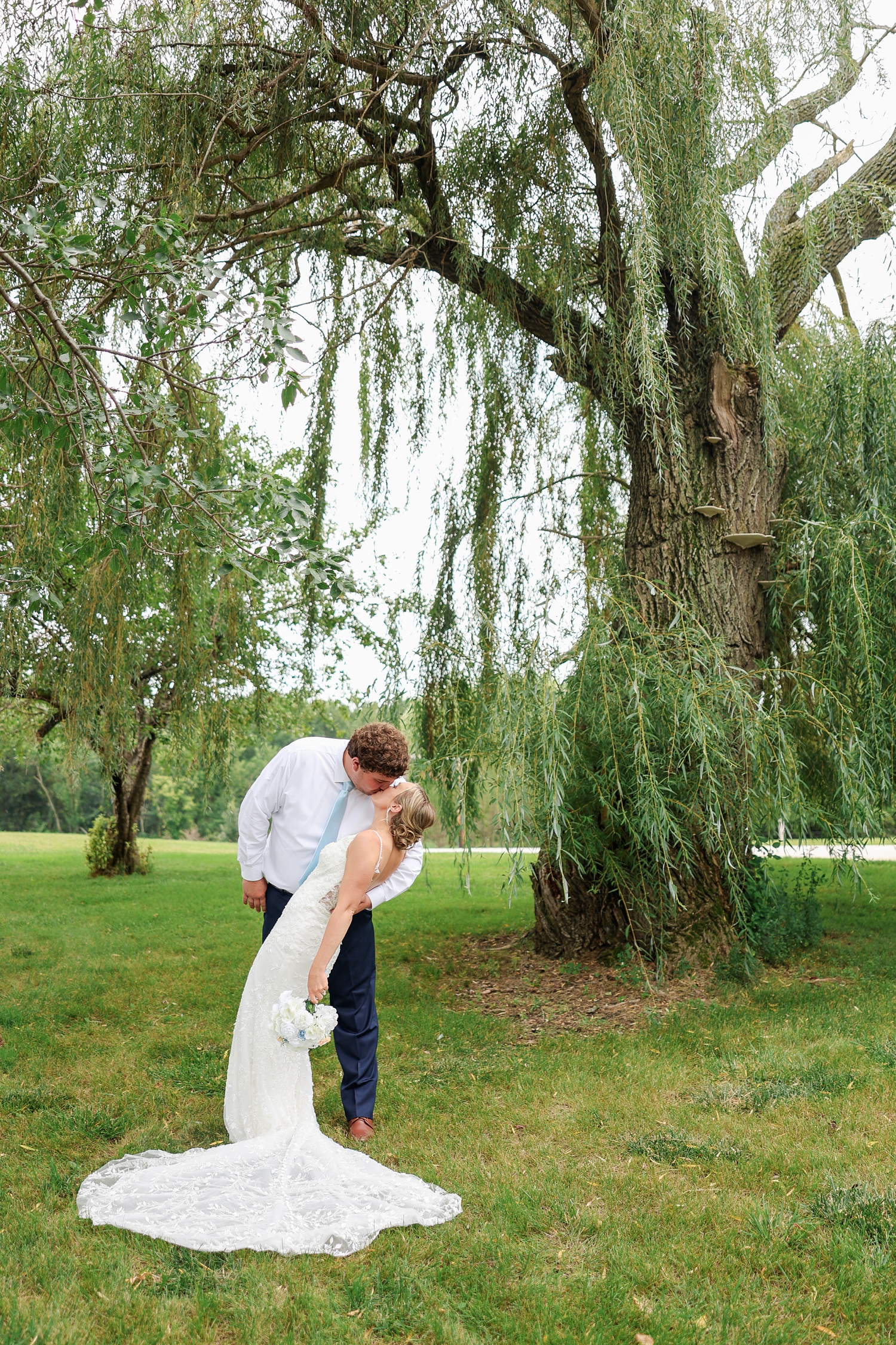 Beneath a willow tree, Brandon dips Alyssa back for a kiss | CB Studio