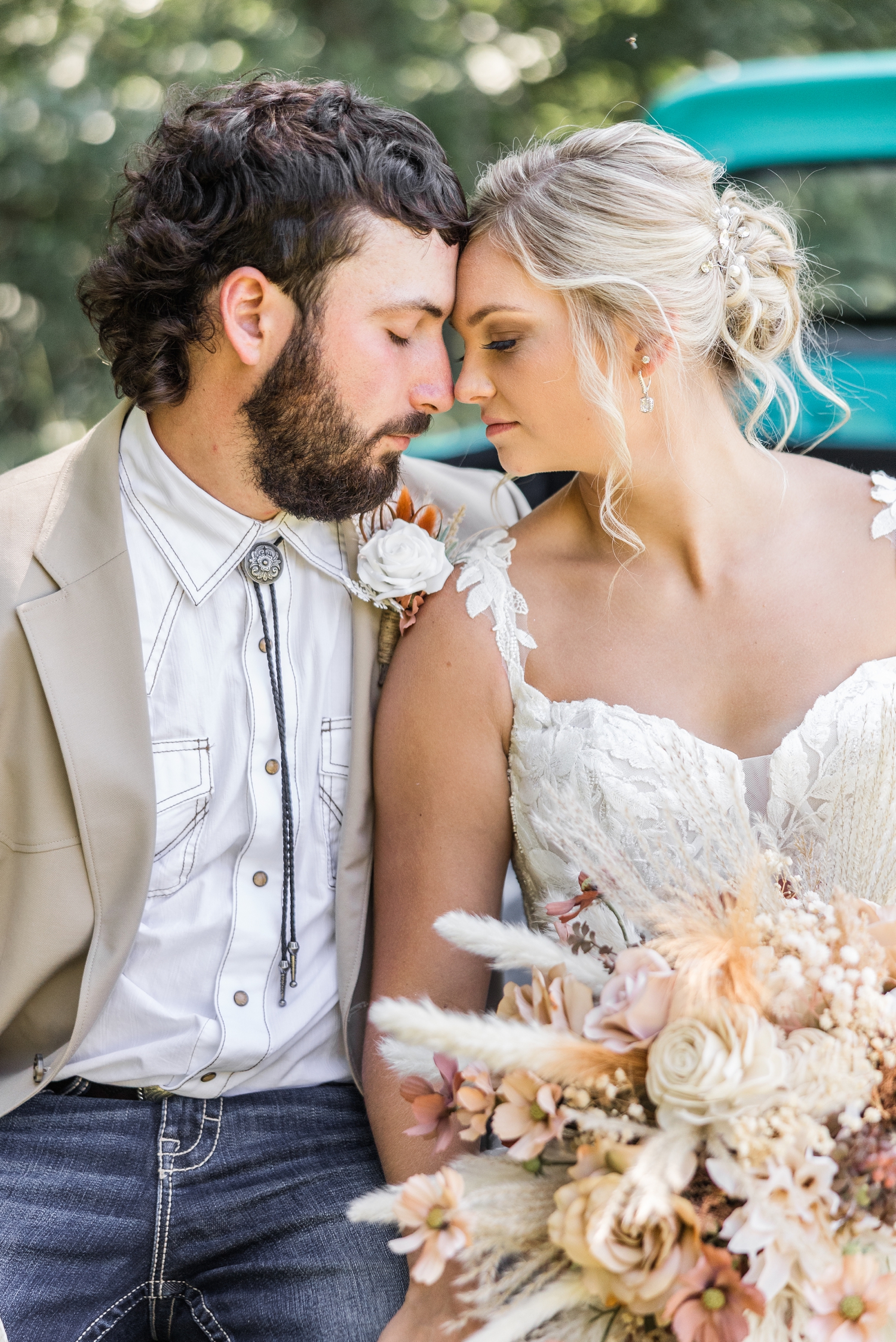 Jade and Dawson sit on the tailgate of an old restored Ford truck as they rest their foreheads together. | CB Studio