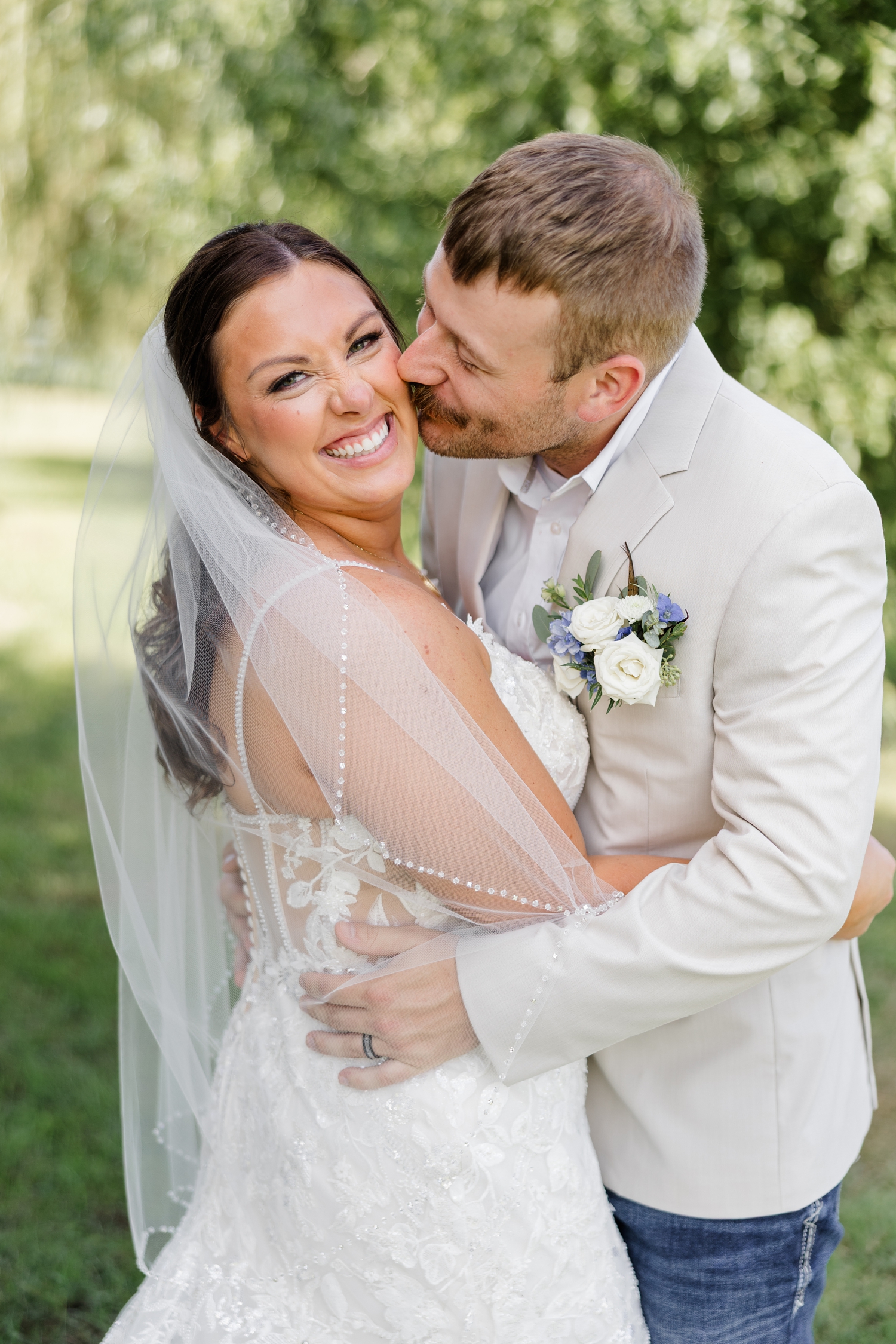 Ryan kisses Cassie's cheek as she laughs in the gardens of River Valley Orchards | CB Studio